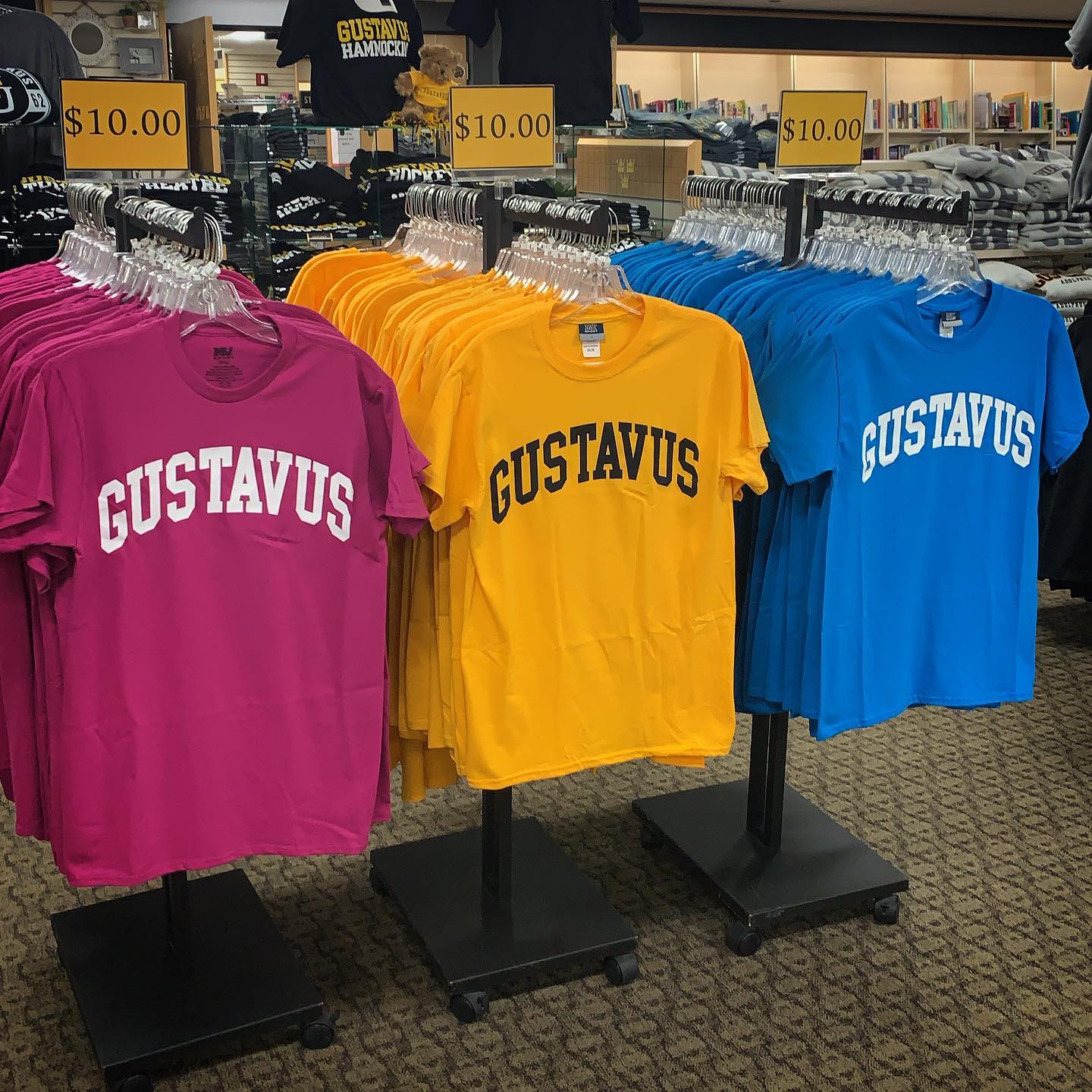 Photo of 3 t-shirts that say Gustavus, each priced at ten dollars.